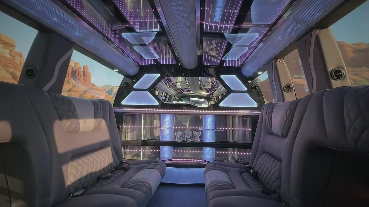 Inside the Cadillac Escalade limo in Colorado Springs: LED light-show ceiling, leather lounge seating and lit bar